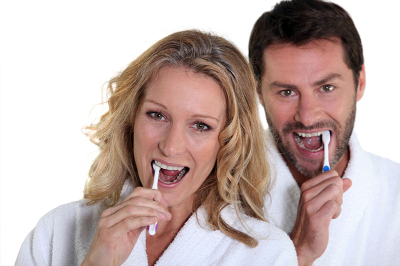 Couple brushing their teeth