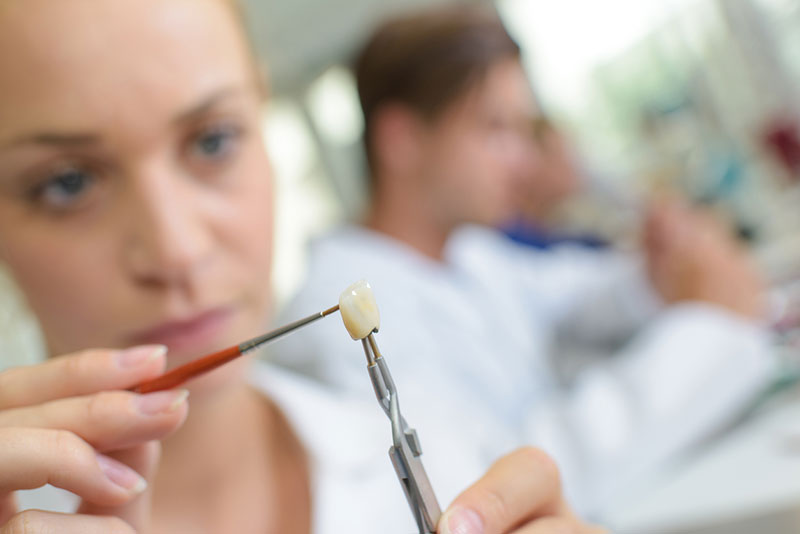 Dental technician working on a crown