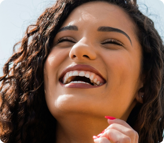 A person smiling confidently with a bright smile.