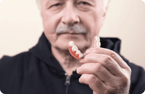 A man displaying his dentures with confidence.